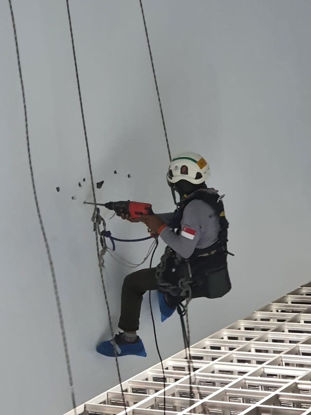 Rope access technician working on façade