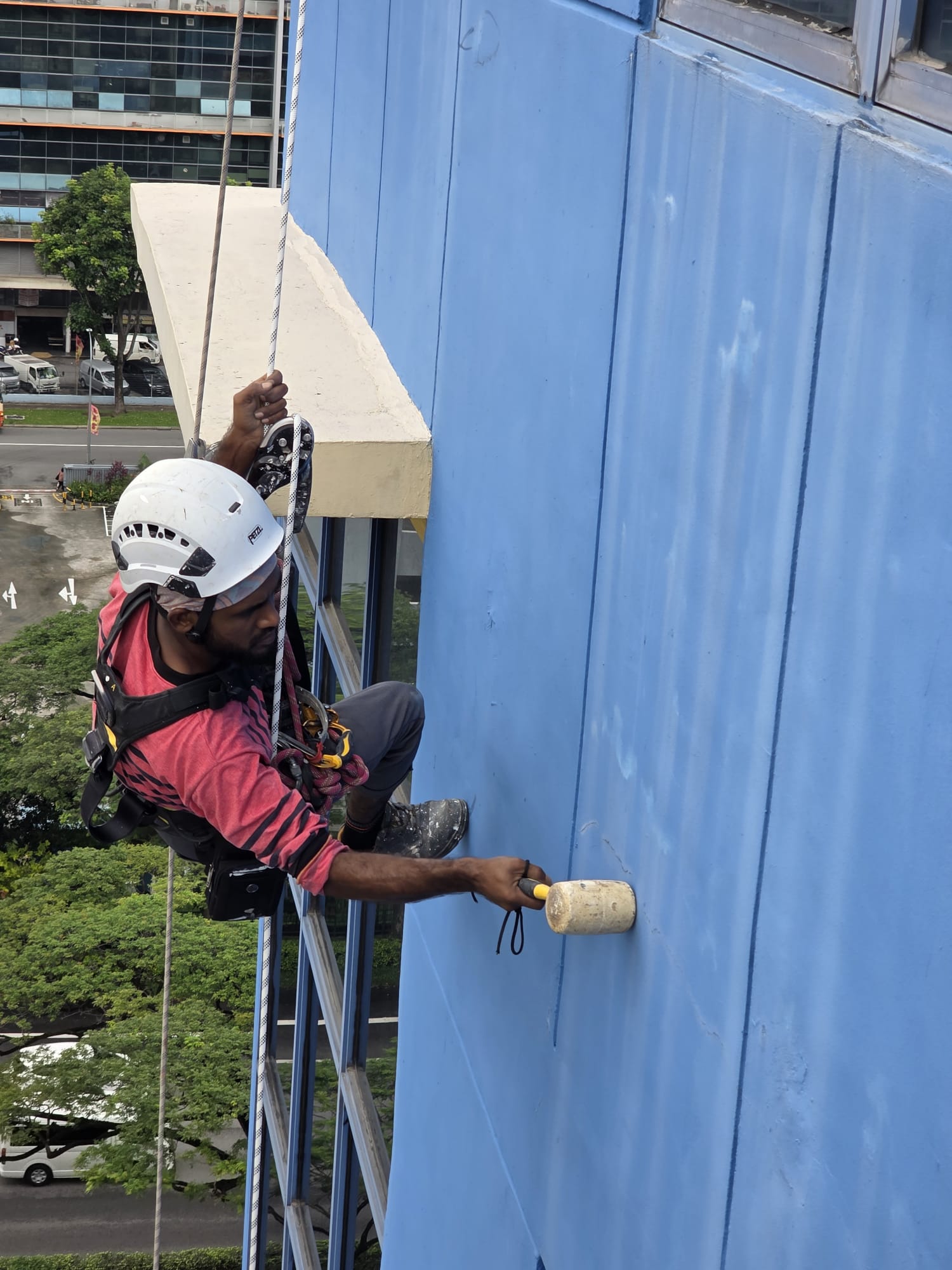 Mallet check on a blue facade panel at Bukit Batok Crescent